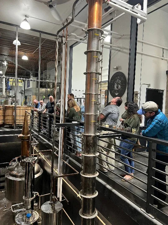 Guests observing the working copper still at Chuckanut Bay Distillery